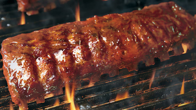 A close up image of the ribs on the grill at Longhorn Steakhouse