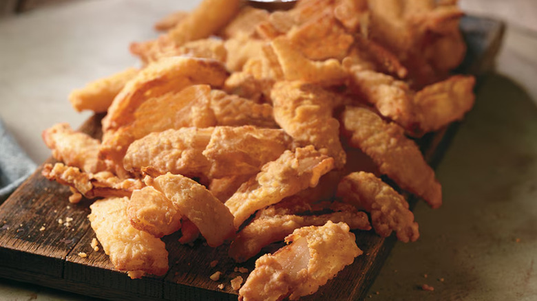 Close up of the Texas Tonion appetizer at Longhorn Steakhouse on a wooden serving tray
