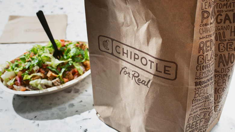 Chipotle chicken salad behind brown bag