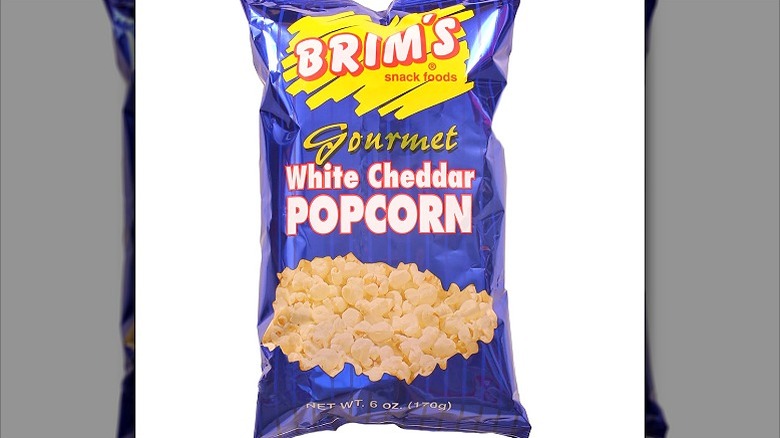 A purple packet of Brim's Gourmet White Cheddar Popcorn