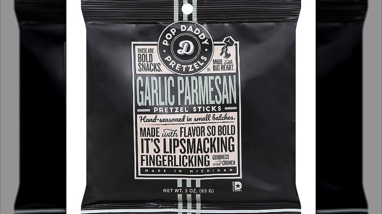 A packet of Pop Daddy Garlic Parmesan Pretzels with text in black, off-white, and light green