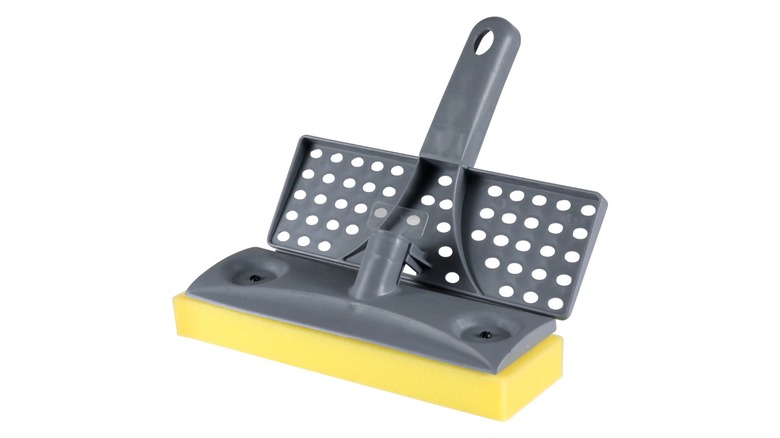 A gray plastic mop head with a yellow sponge