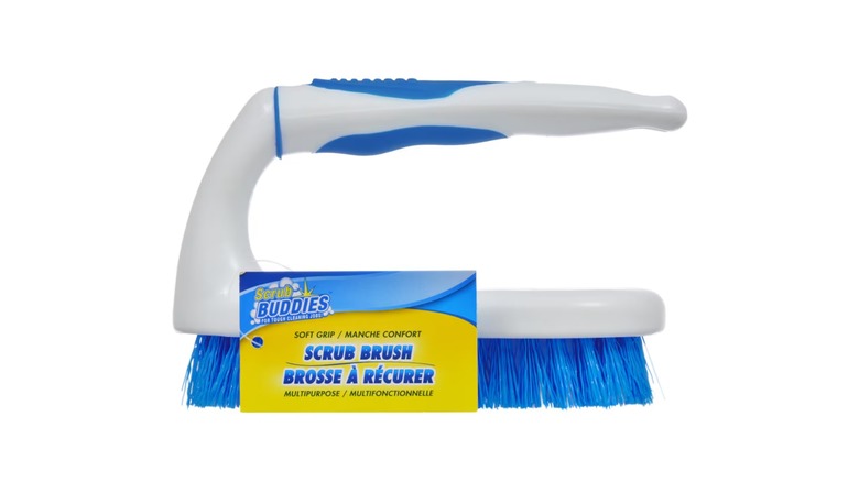 A blue scrubbing brush with a white handle