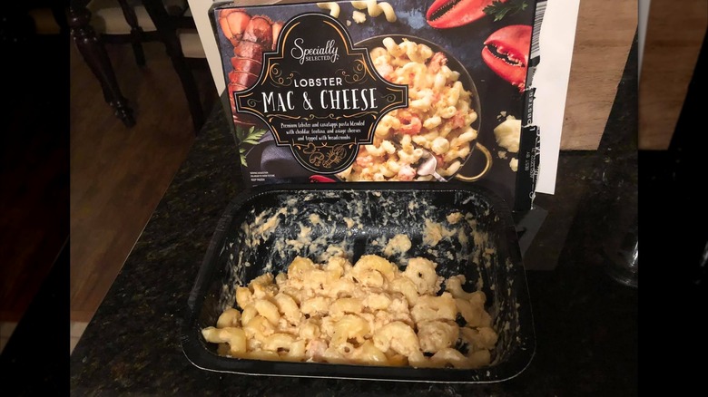 Lobster mac and cheese in black plastic container