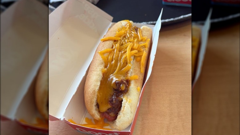 A sad-looking Dairy Queen chili cheese dog in a paper box on a table