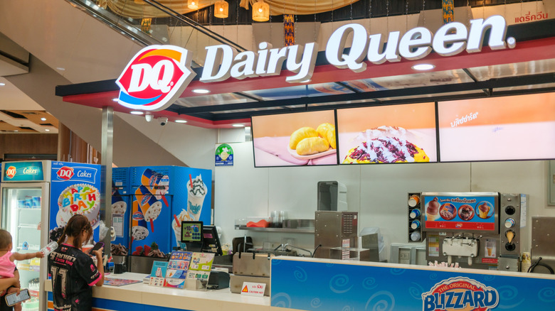 People stand in line at a Dairy Queen counter waiting to order their food