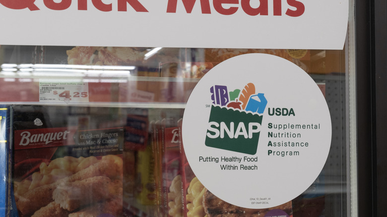 Close-up of a SNAP sticker on grocery cooler door