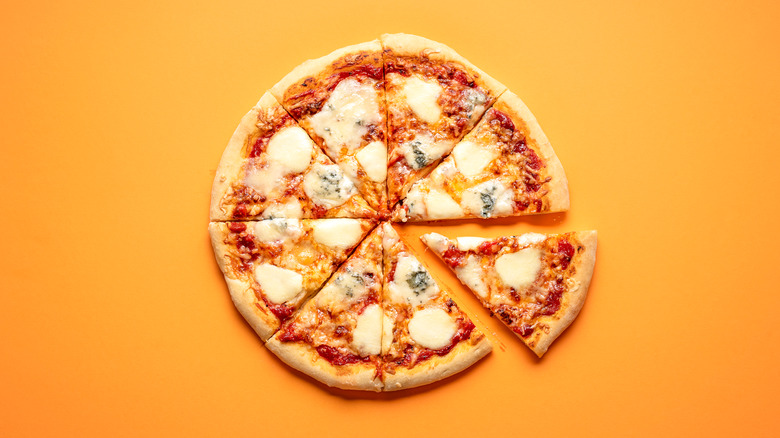 A pizza pie on an orange background
