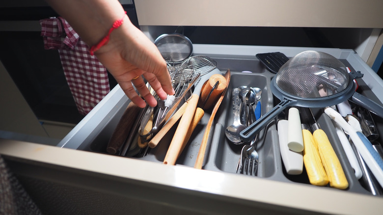 Cluttered drawer of kitchen tools