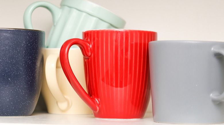 Collection of coffee mugs on shelf