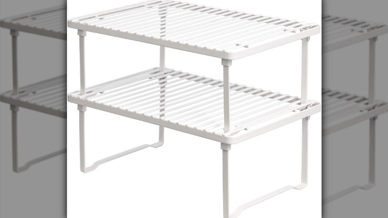 Two-tier white shelf on white background.