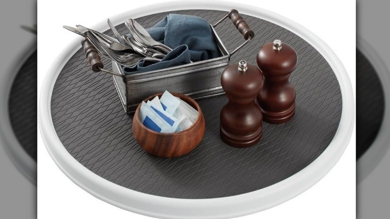 Lazy Susan with kitchen items on white background.