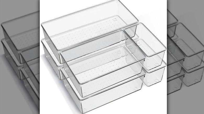 Set of small storage bins on white background.