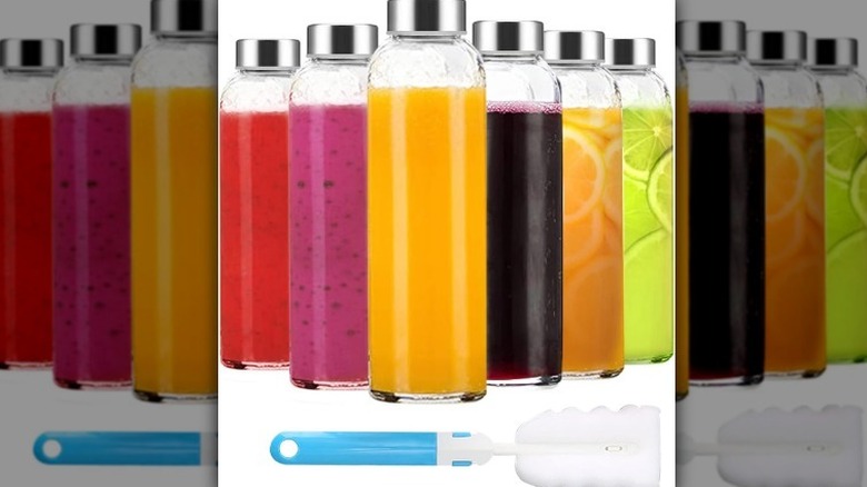 Glass beverage containers on white background with bottle brush.