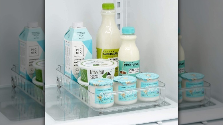 Milk and yogurt in roll-out fridge caddy.