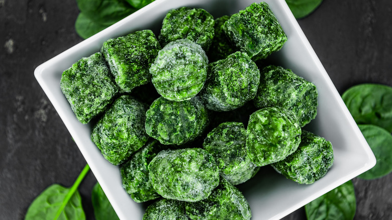 Frozen spinach cubes in bowl