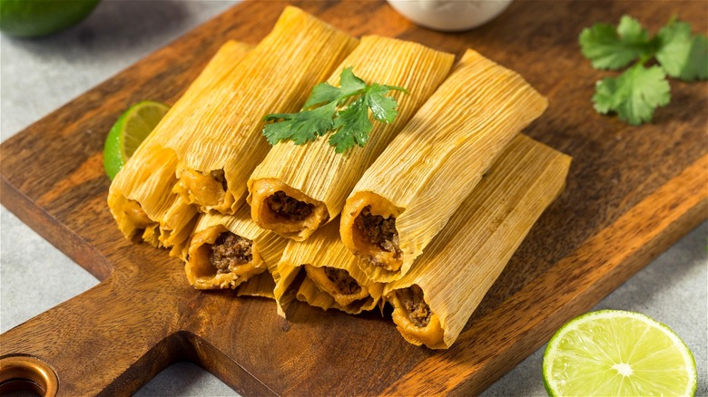Tamales on wooden cutting board 