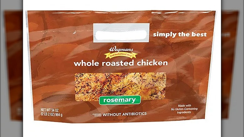 A brown bag with a Wegmans whole roasted chicken, rosemary written on it and a photo of seasoned chicken breast