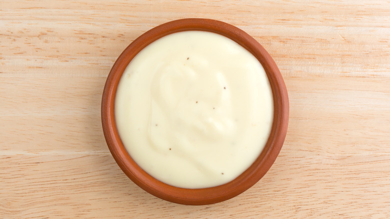 Blue cheese dressing in a small tan bowl