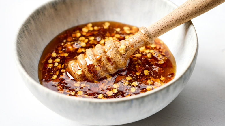 Hot honey in a bowl with crushed red pepper flakes
