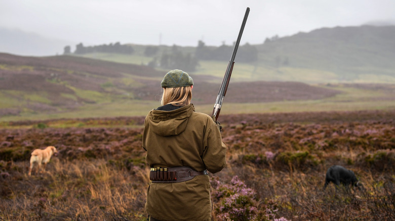 woman and dogs hunting highlands