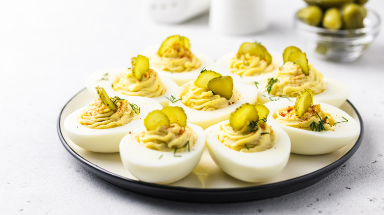 Deviled eggs garnished with pickles