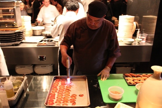 A Cook From O Ya Torching Tomatoes for the Salmon Tataki Nigiri