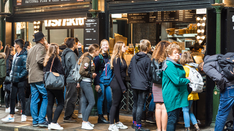 A line of people at a restaurant