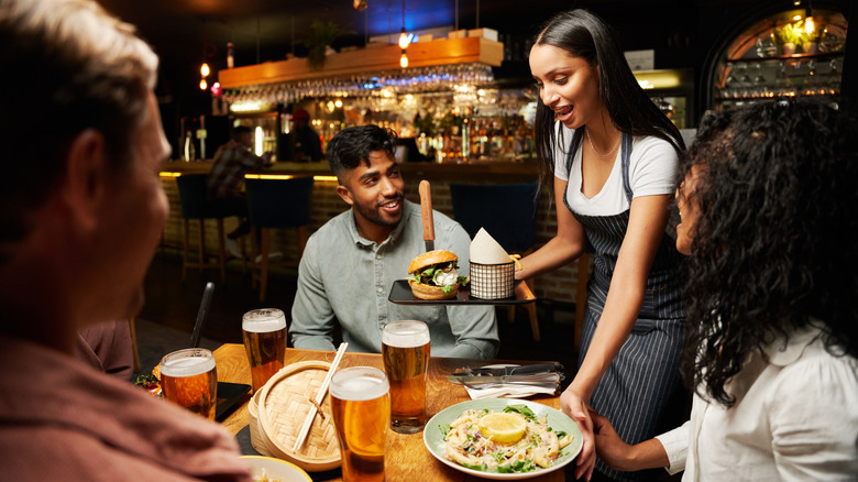 Waitress holding plates of food