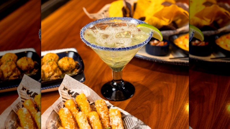 Margarita, mozzarella sticks, and chips with queso