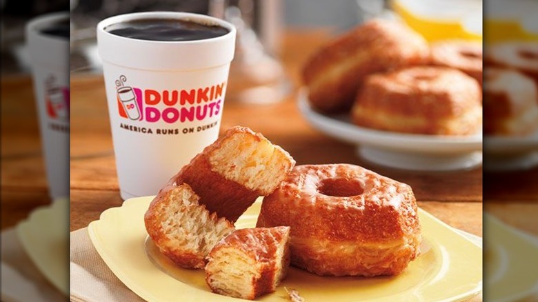 Croissant donut on a plate served with hot coffee