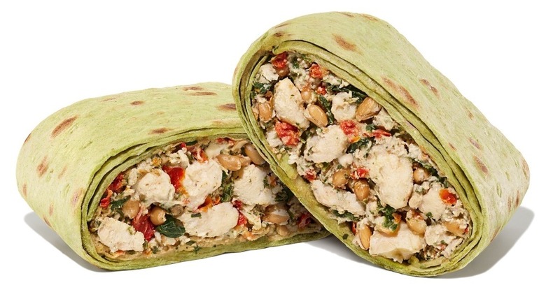 Dunkin' green goddess wrap, sliced in half to show its mixed filling