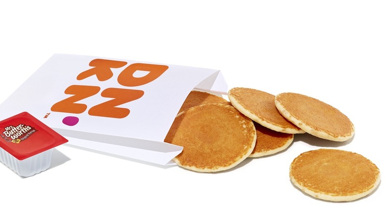 A paper bag with pancake minis spilling out