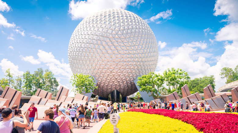 The sphere at EPCOT being approached by various parkgoers