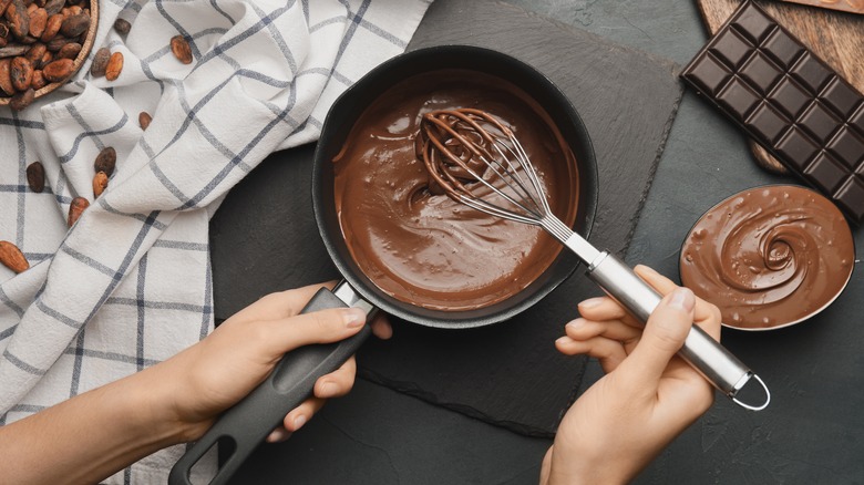 person whisking melted chocolate