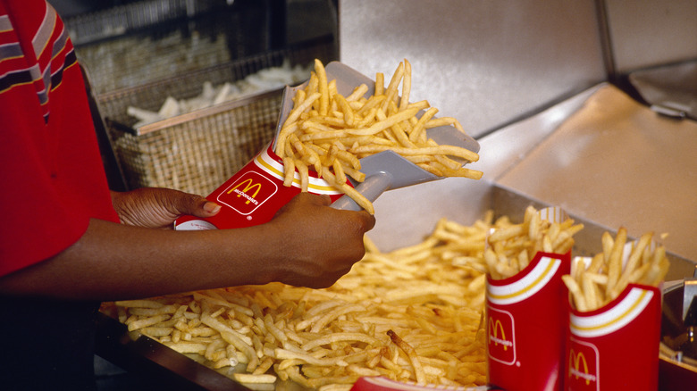 worker serving McDonald's fries