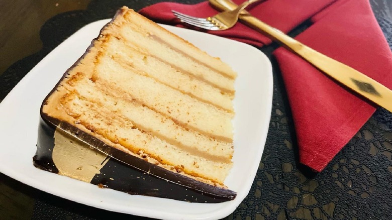 slice of caramel doberge cake on plate