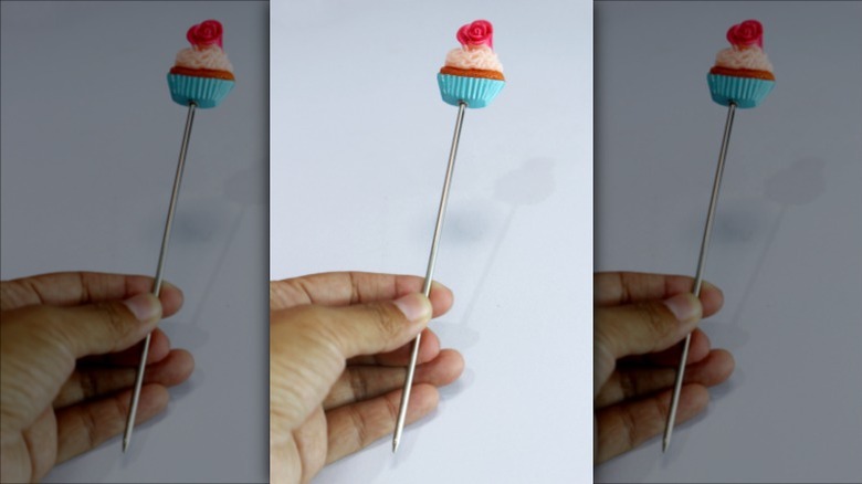 Cake tester impaling cupcake