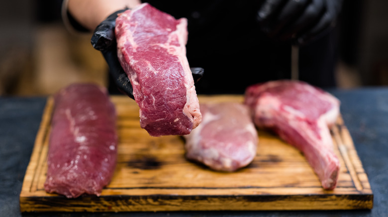Fresh cuts of meat on a wooden board
