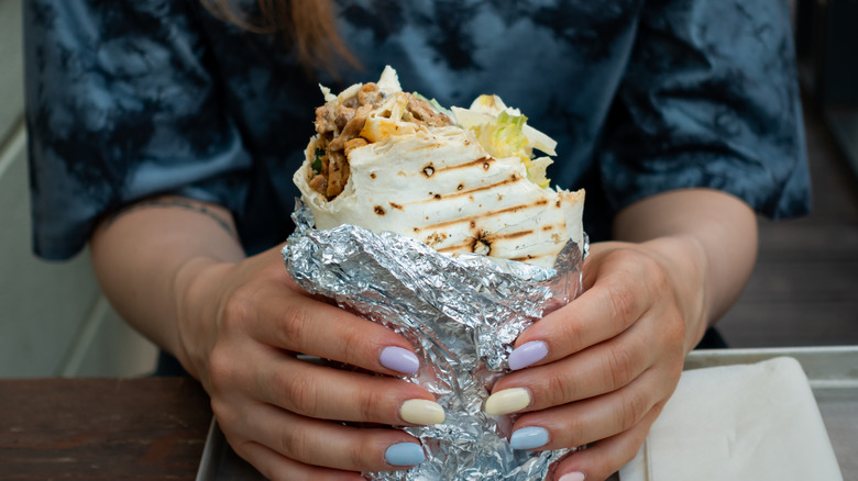 Person holding vegan wrap