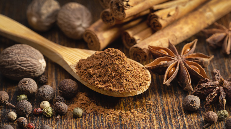 Ground cinnamon surrounded by other spices