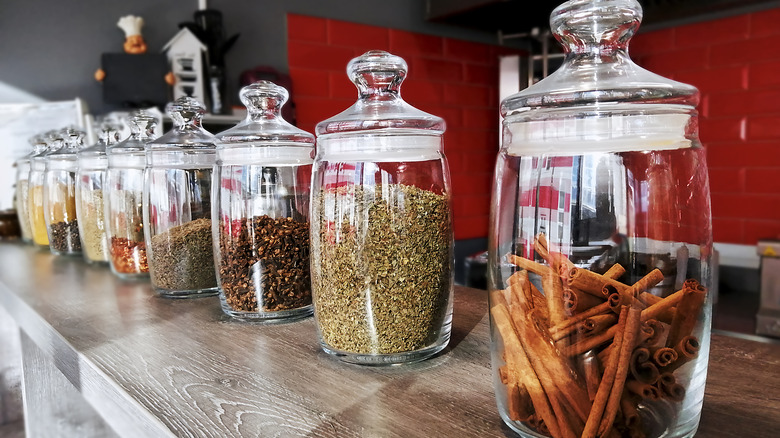 Cinnamon sticks and other spices in containers