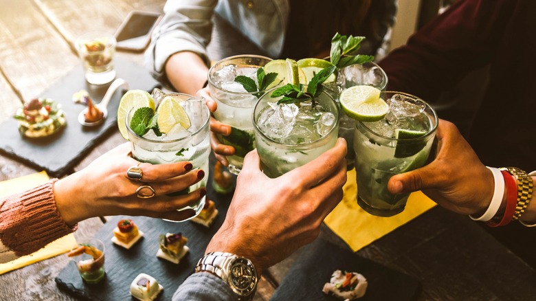 Group of people toasting cocktails 