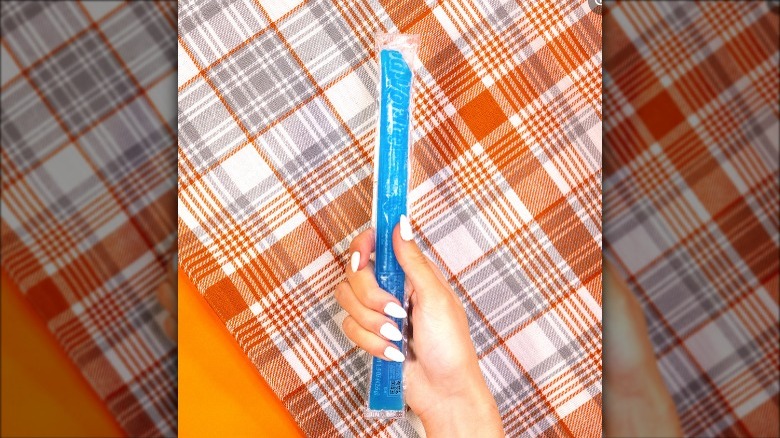a person holding a flavor ice pop