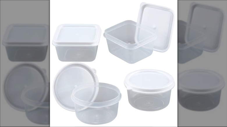 Four clear storage containers with plastic lids, two are round and two are square