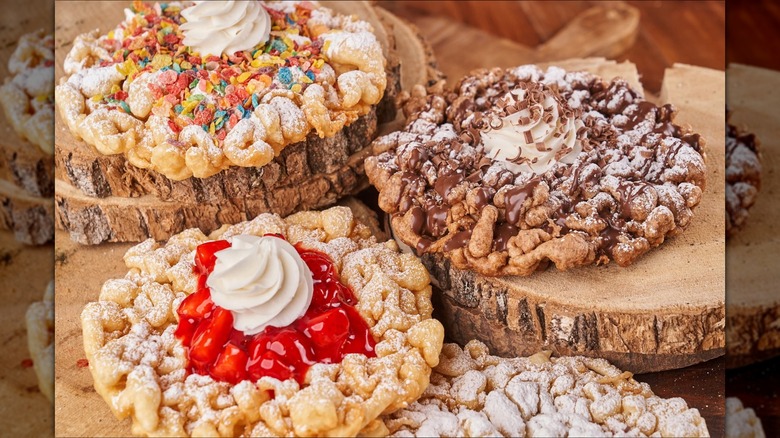 Dollywood funnel cakes with various toppings on tree stumps