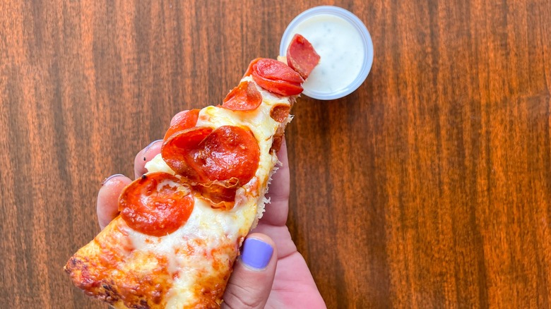 slice of pizza dipped into ranch
