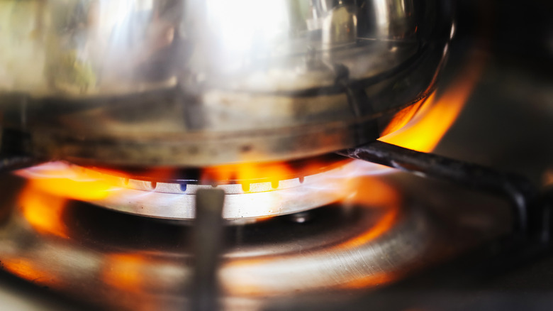 Orange flame under pan on gas stovetop
