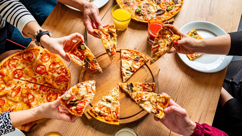 Friends sharing a pizza at a restaurant