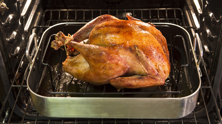 A roast chicken in a roasting tray